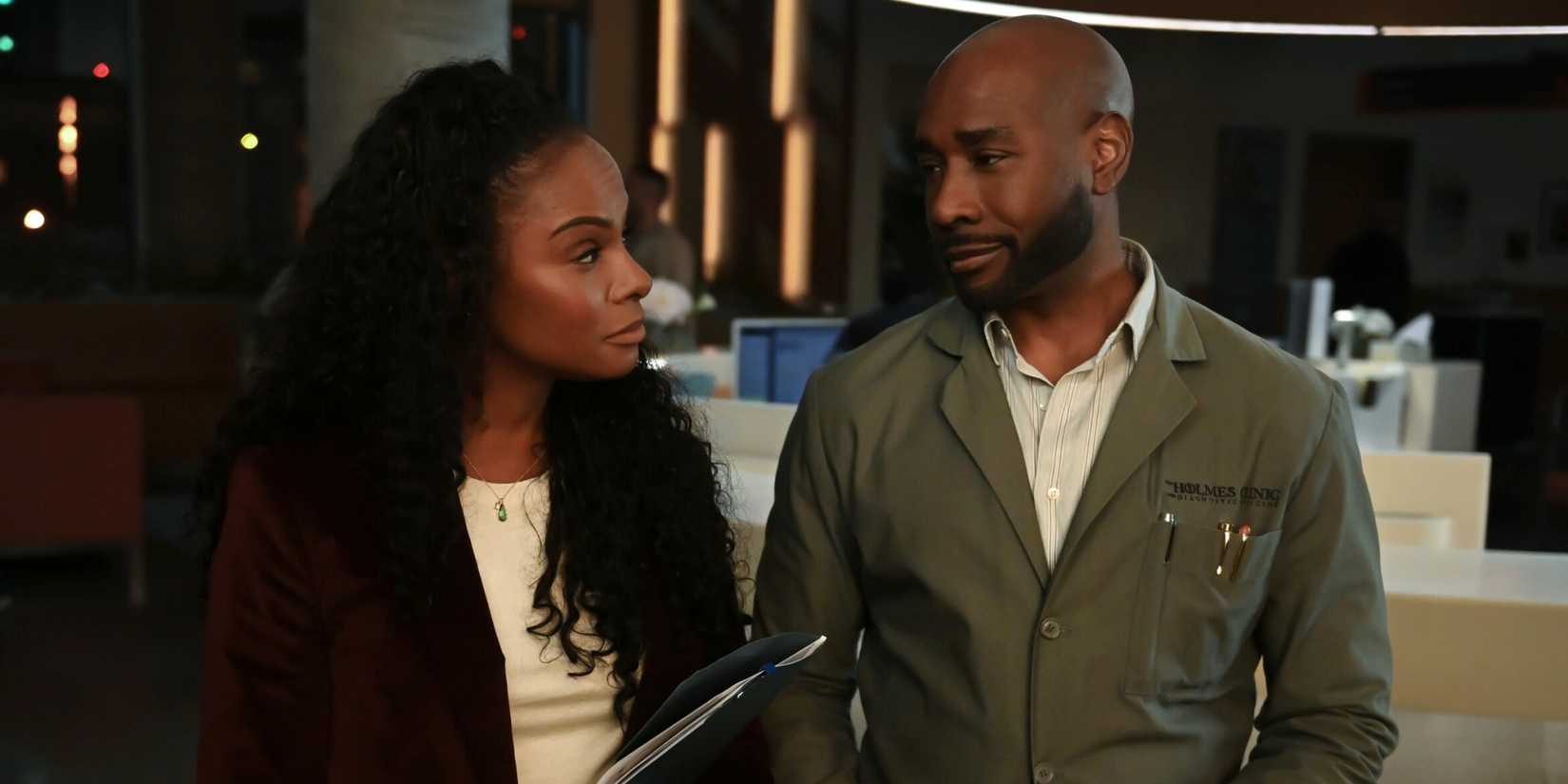 Morris Chestnut as John Watson standing next to Tika Sumpter as Laila in the hospital in Watson Season 1