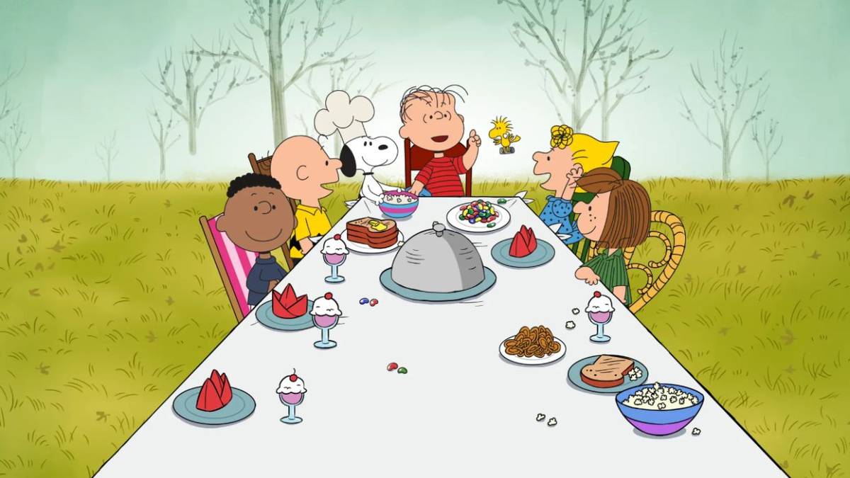 Linus, Snoopy, Charlie, Sally, Peppermint Patty, and Franklin gathered around a table in 'A Charlie Brown Thanksgiving'