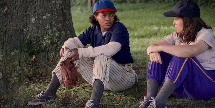 Max and Carson in baseball outfits sitting outside in 'A League of Their Own'