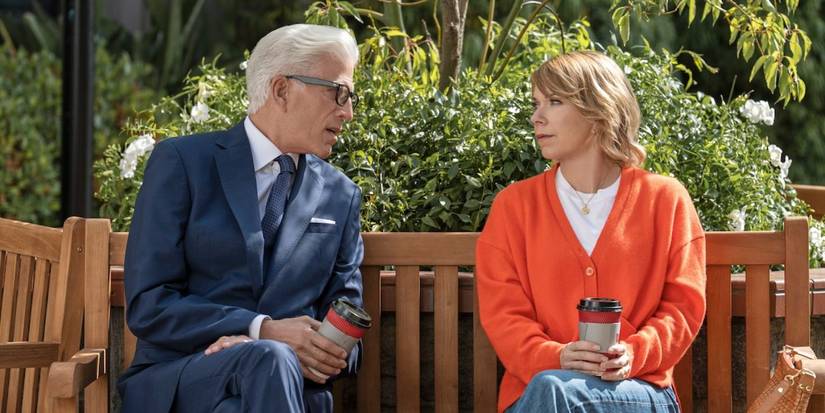 Charles (Ted Danson) and Emily (Mary Elizabeth Ellis) sitting on a bench with coffee in 'A Man on the Inside' Season 2.