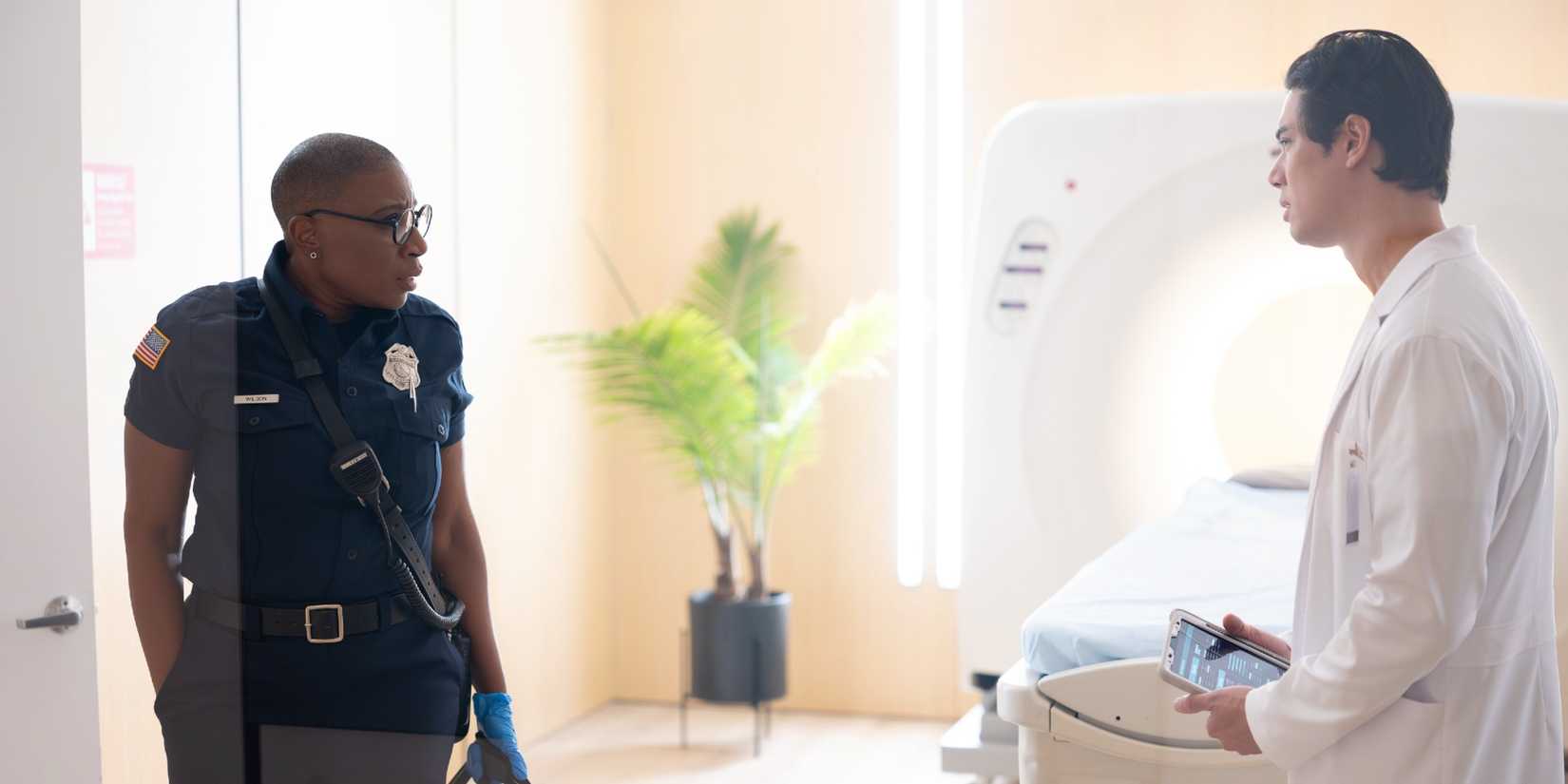 Hen Wilson speaking to a doctor while on duty in 9-1-1 Season 9