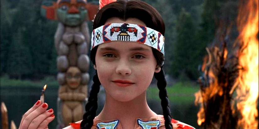 Wednesday Addams (Christina Ricci) in a Native American costume with a match in 'Addams Family Values'