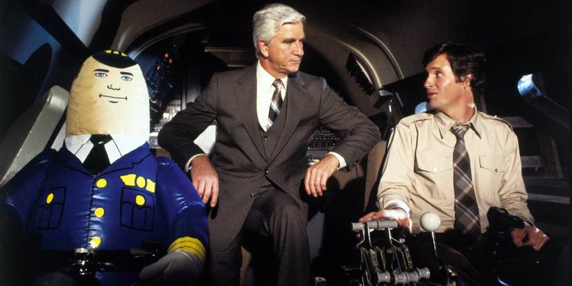 Leslie Jordan in the cockpit with a pilot and a pilot doll in Airplane!