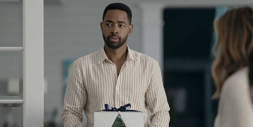 Colin holding a cake in a box in All Her Fault.