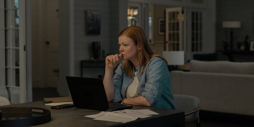 Marissa in the kitchen sitting at her computer thinking in All Her Fault.