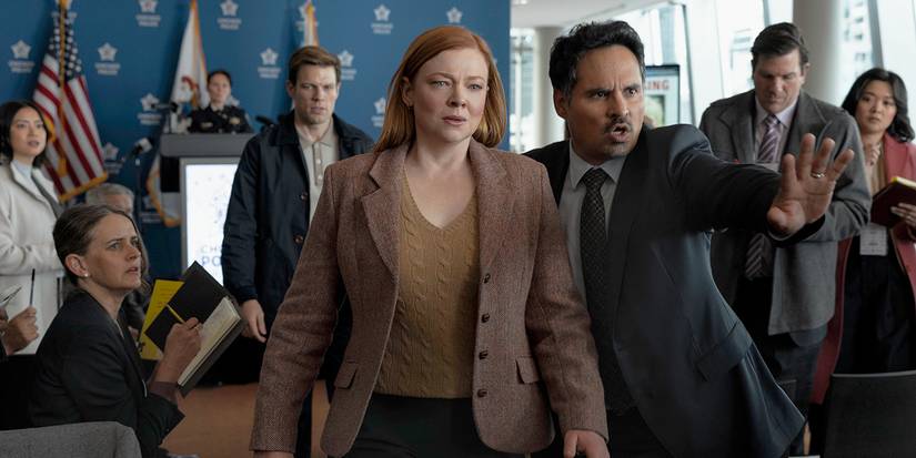 Sarah Snook and Michael Pena walking through a crowd in All Her Fault