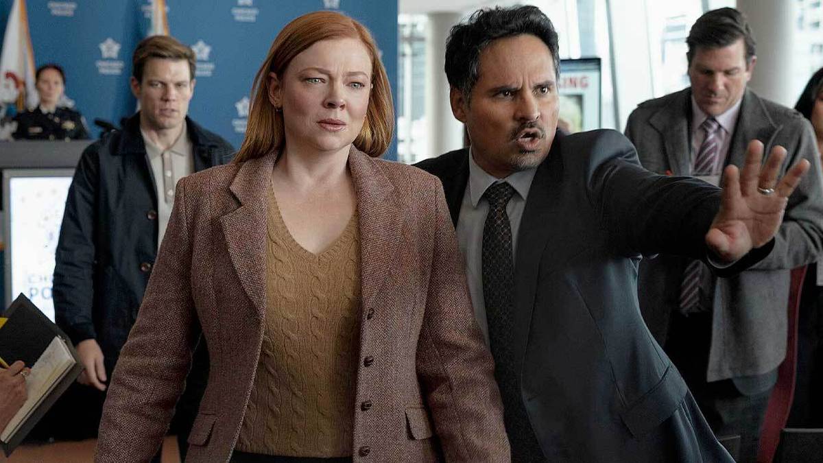 Sarah Snook and Michael Peña make their way through a crowd in All Her Fault.