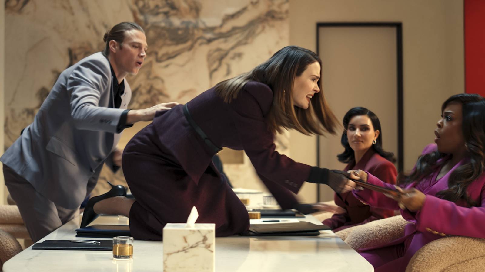 Sarah Paulson lunges over a table toward Niecy Nash-Betts during a meeting in All's Fair