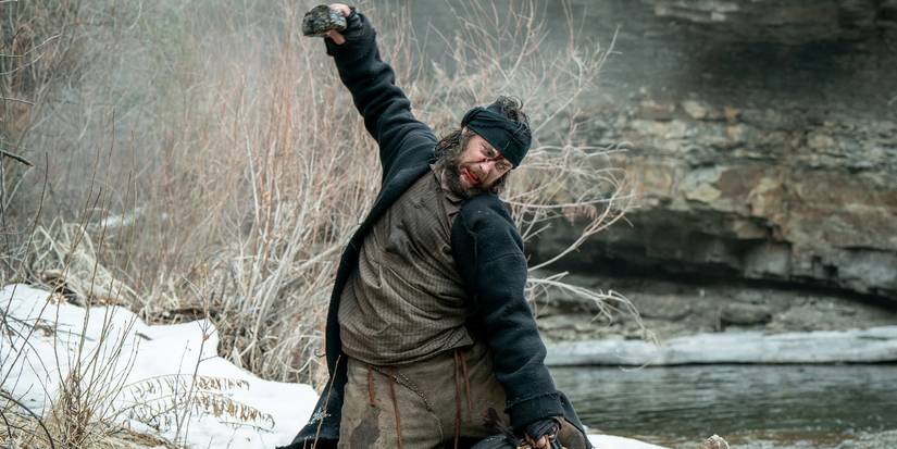Taylor Kitsch as Isaac Reed raising his fist during a fight on 'American Primeval.'