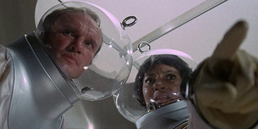 A man and a woman in helmet and safety suit looking concerned