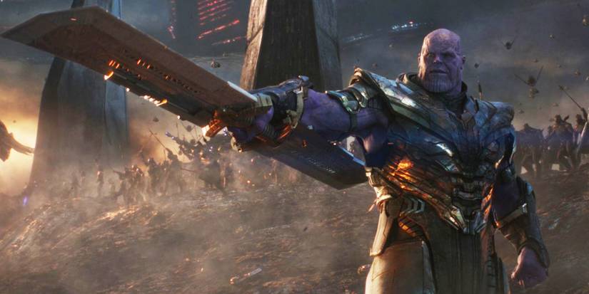 Josh Brolin as Thanos pointing off-screen with destruction behind in Avengers: Endgame, 2019.