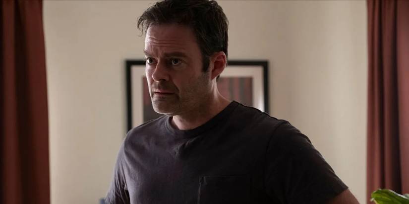 A stressed and dejected looking Barry Berkman (Bill Hader) stands in a black t-shirt in 'Barry' (2018-2023).