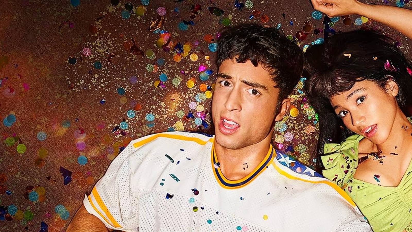 The promo poster for Overcompensating featuring Benito Skinner as Benny and Wally Baram as Carmen lying on the floor surrounded by confetti