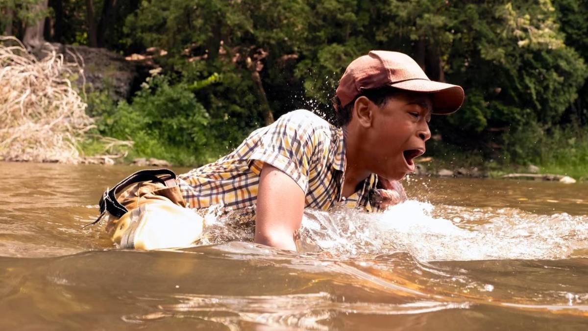 Will (Blake Cameron James) being pulled into the river in 'IT: Welcome to Derry'