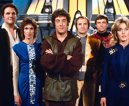 The original cast of Blake's 7 standing on the bridge of the Liberator