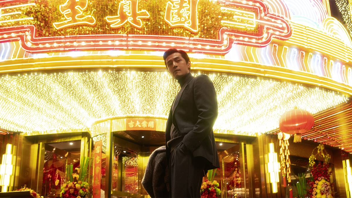 Hu Ge as Ah Bao standing in front of the Grand Lisbon restaurant in Blossoms Shanghai