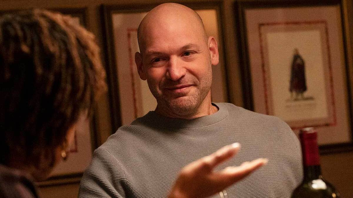 Corey Stoll smirking in HBO's Scenes From a Marriage at a dinner table 