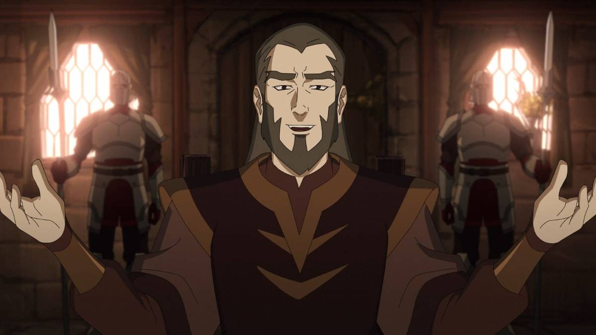 Trent Ikithon talking with a pleasant smile and his hands raised in The Mighty Nein