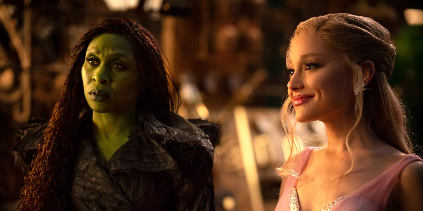 Cynthia Erivo and Ariana Grande look at something off camera in dim light in Wicked: For Good.