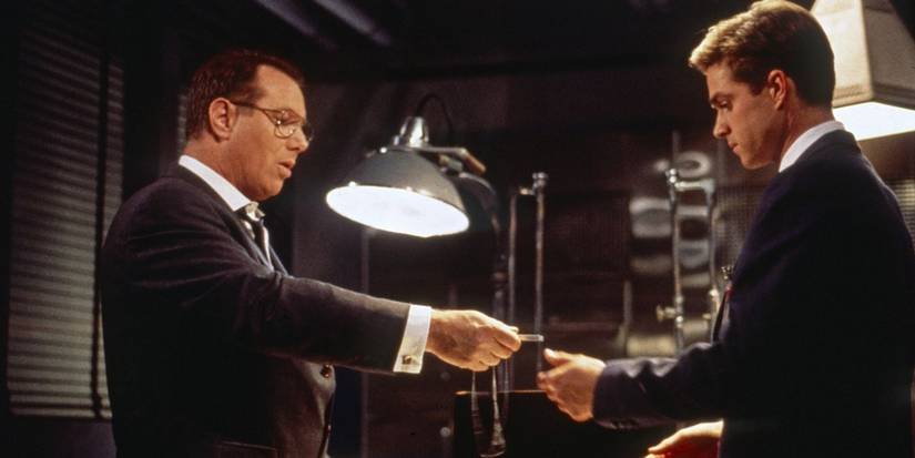 Man in a suit handing over something to another man