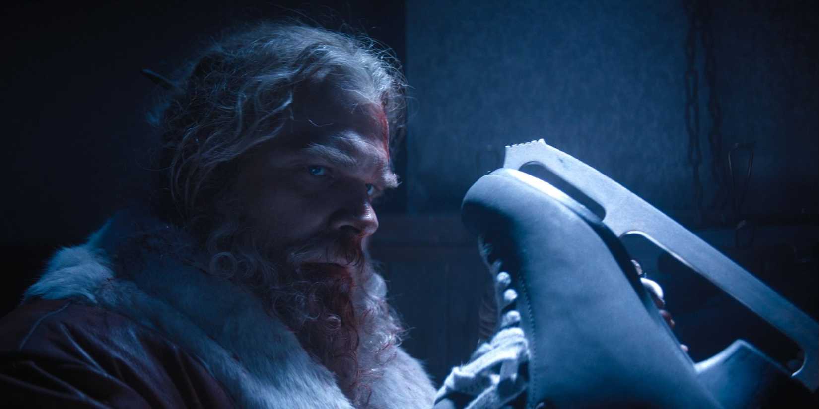 David Harbour as Santa holding an ice skate and looking to the side intensely in Violent Night.