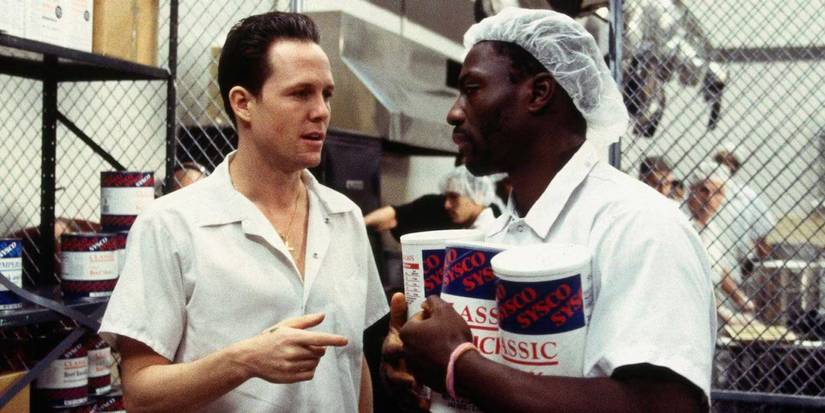 Ryan and Adebesi talk in the kitchen in Oz.