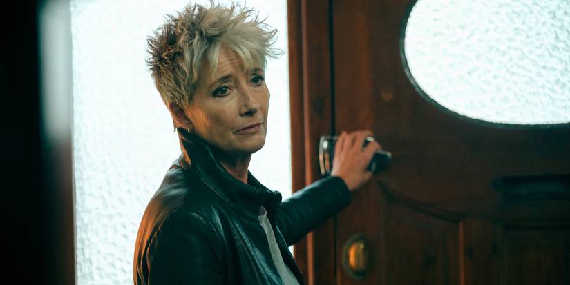 Emma Thompson as Zoe reaching out to hold onto the door latch in Down Cemetery Road.