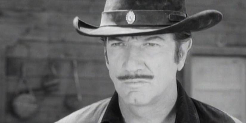 Paladin (Richard Boone) looks at his opponent in the 'Have Gun — Will Travel' episode "The Manhunter".