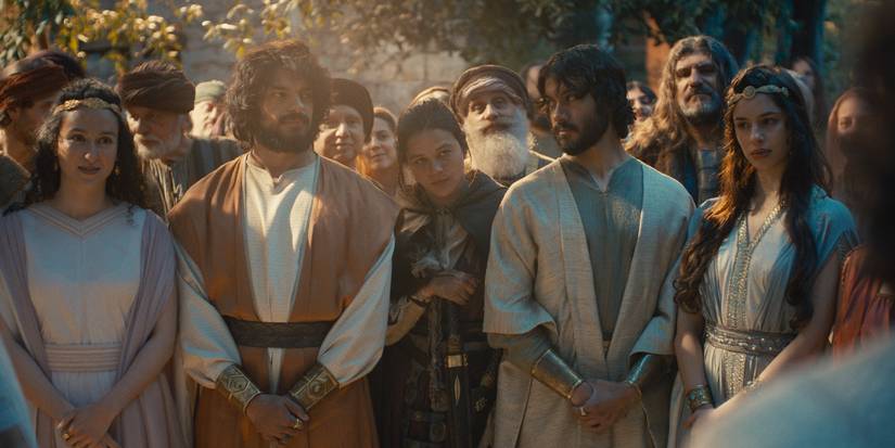 Sara, Jonathan, Dina, Eshbaal, and Mirab stand among attendees at David and Mychal's wedding in House of David Season 2