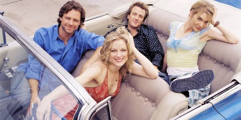 The cast of I'm With Her looking up at the camera from a convertible car with the top down. 