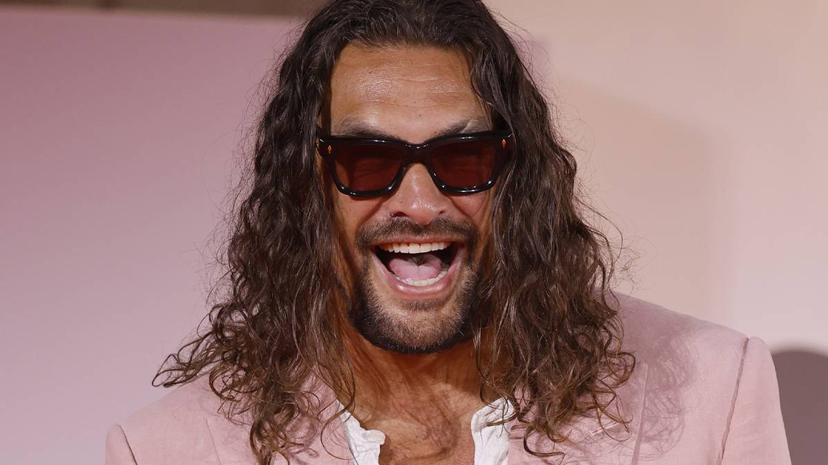 Jason Momoa smiling on the red carpet 