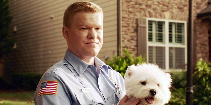 Gary in a police uniform holding a dog