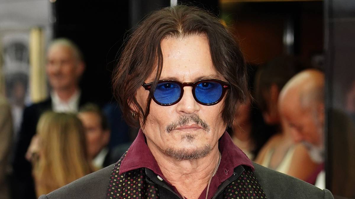 Johnny Depp wearing sunglasses on a red carpet