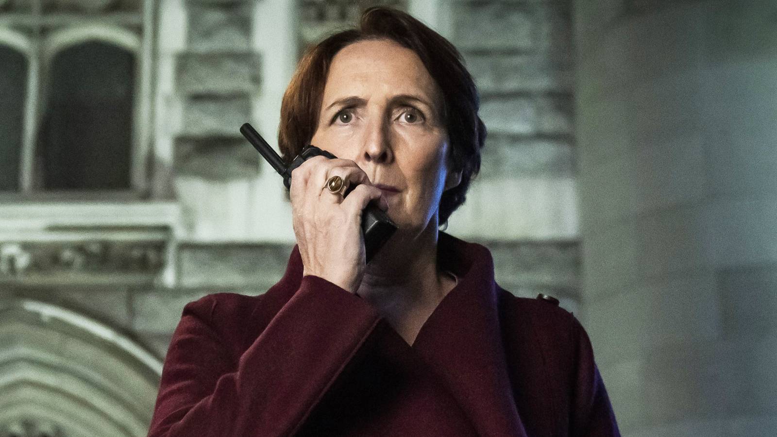 Fiona Shaw walking and on the phone as Carolyn Martens in Killing Eve