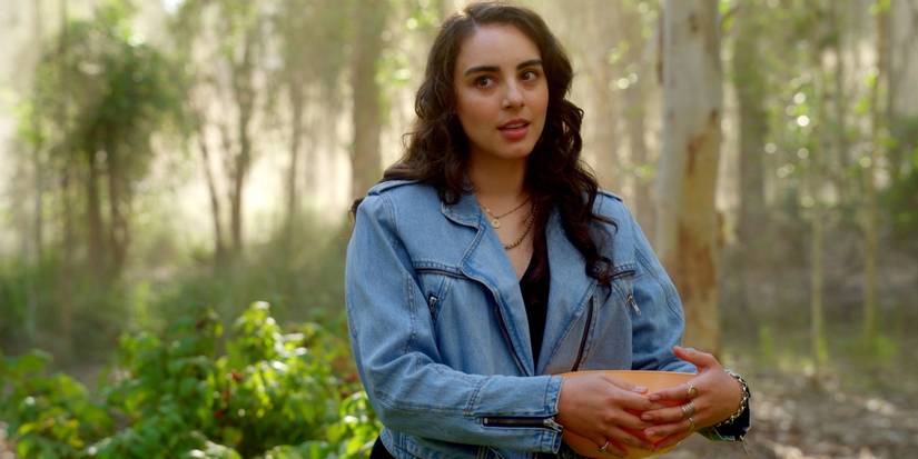 Riley, holds a bowl, in the woods in 'La Brea'