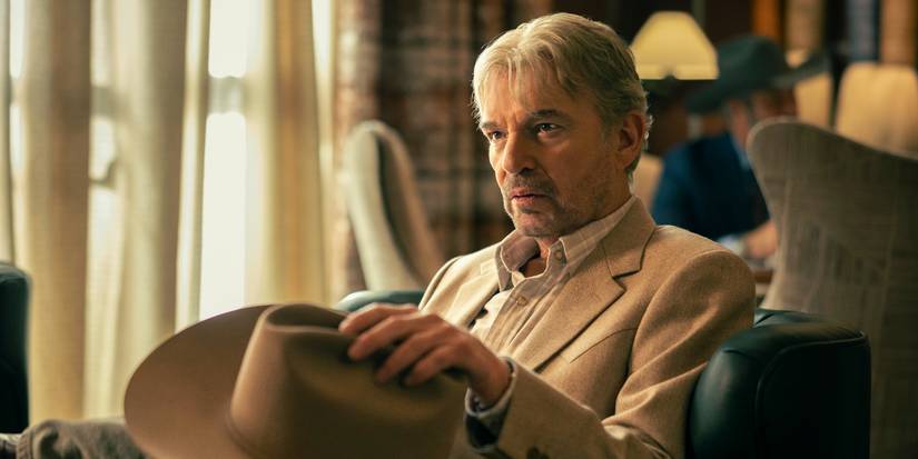 Billy Bob Thornton as Tommy Norris sitting in a chair, holding his hat and talking in Landman.