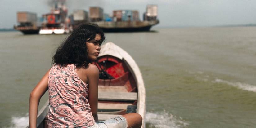 Marcielle on a boat, looking over her shoulder.