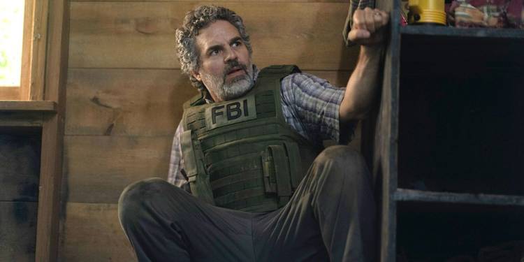 Tom in a FBI vest, crouched on the floor