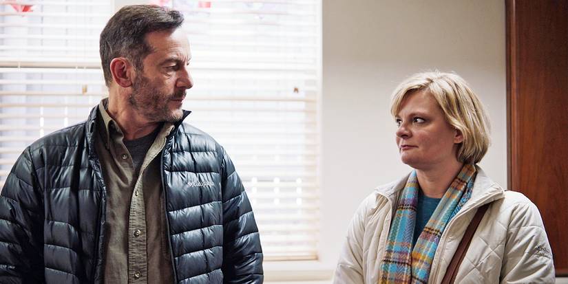 Jason-Isaacs and Martha-Plimpton looking at each other in Mass
