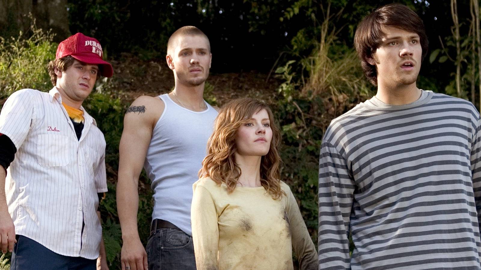 A group of teens stand in the woods looking at something off camera in House of Wax