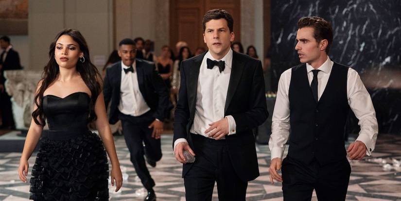 Ariana Greenblatt, Jesse Eisenberg, and Dave Franco walk through a black-tie event in Now You See Me 3.