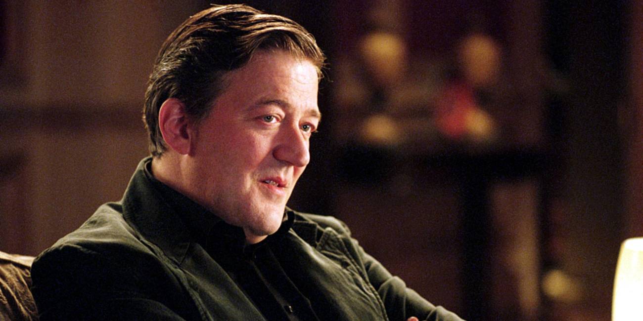 Stephen Fry seated in V for Vendetta