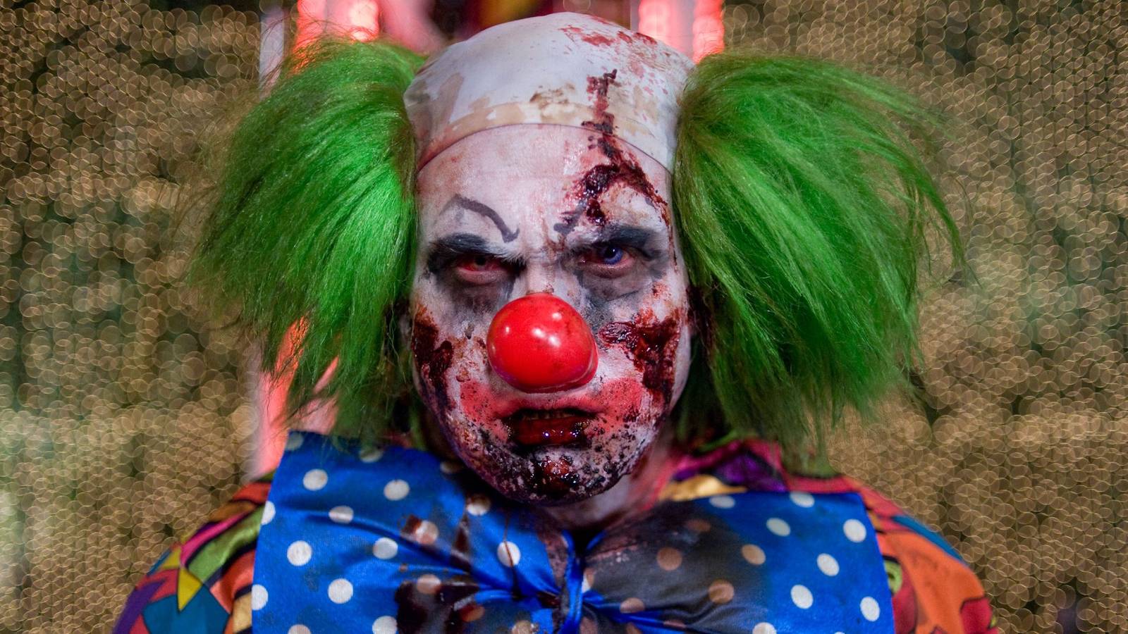 a clown-zombie faces the camera in close-up in Zombieland