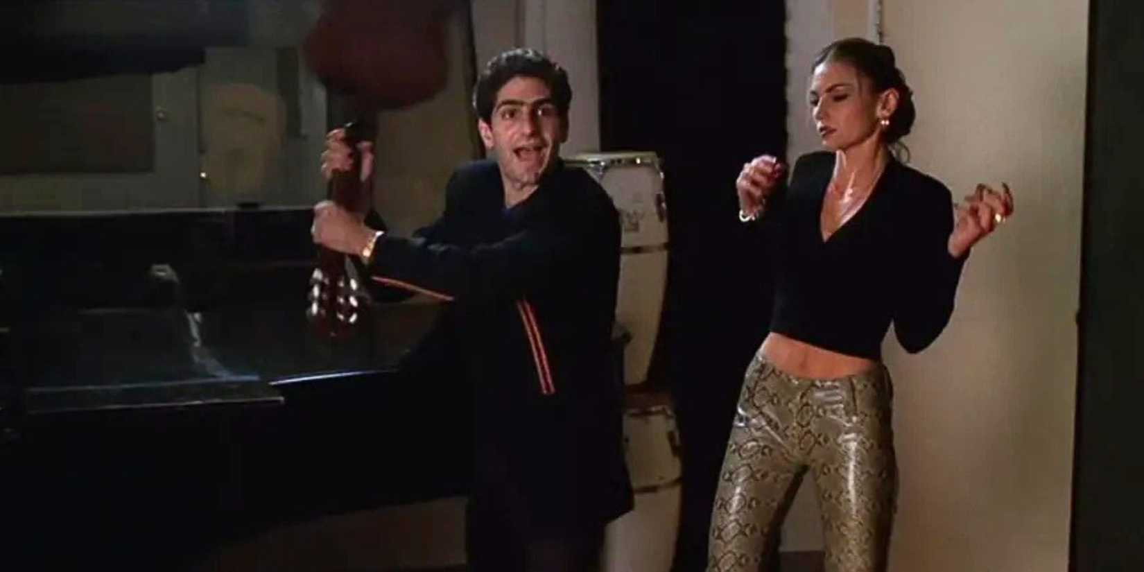 Michael Imperioli as Christopher Moltisanti standing in a recording studio holding a guitar over his head while Drea De Matteo as Adriana La Cerva is standing next to him in The Sopranos episode A Hit is a Hit