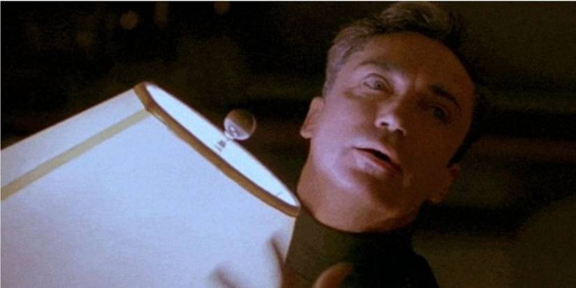 Udo Kier holding a lamp in My Own Private Idaho