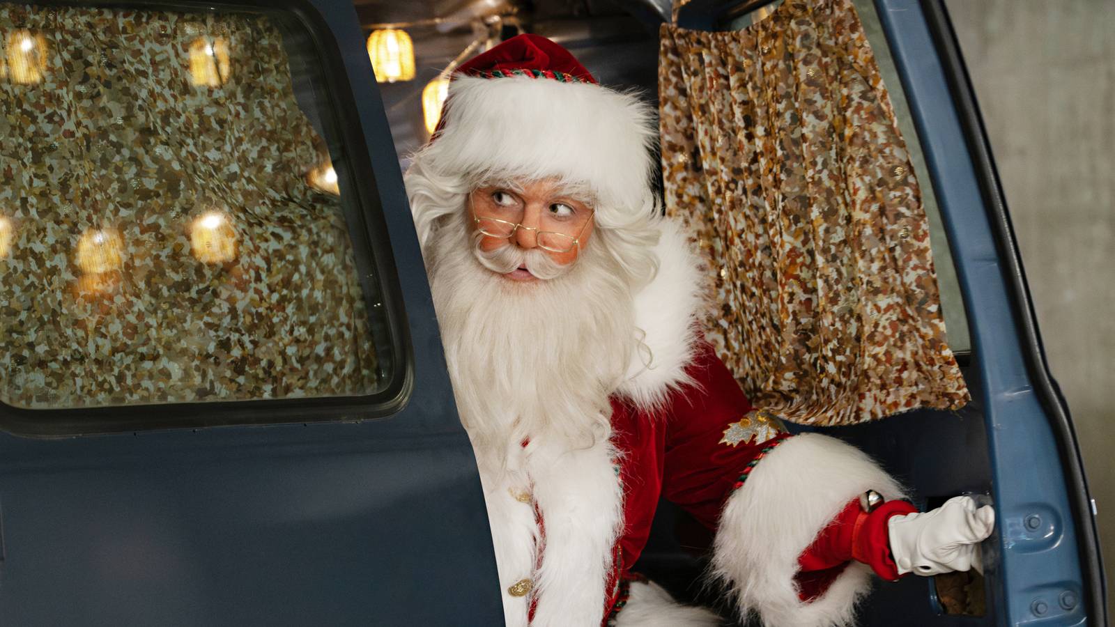 Actor Alexandra Breckenridge as Taylor, dressed as Santa Claus and climbing out the back of a van in My Secret Santa.