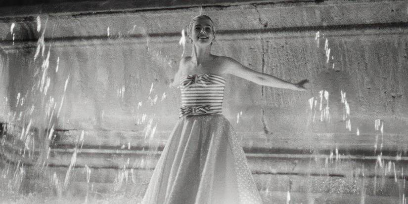 Patricia (Jean Seberg played by Zoey Deutch) twirls in the Fontaine des Mers in Breathelss.