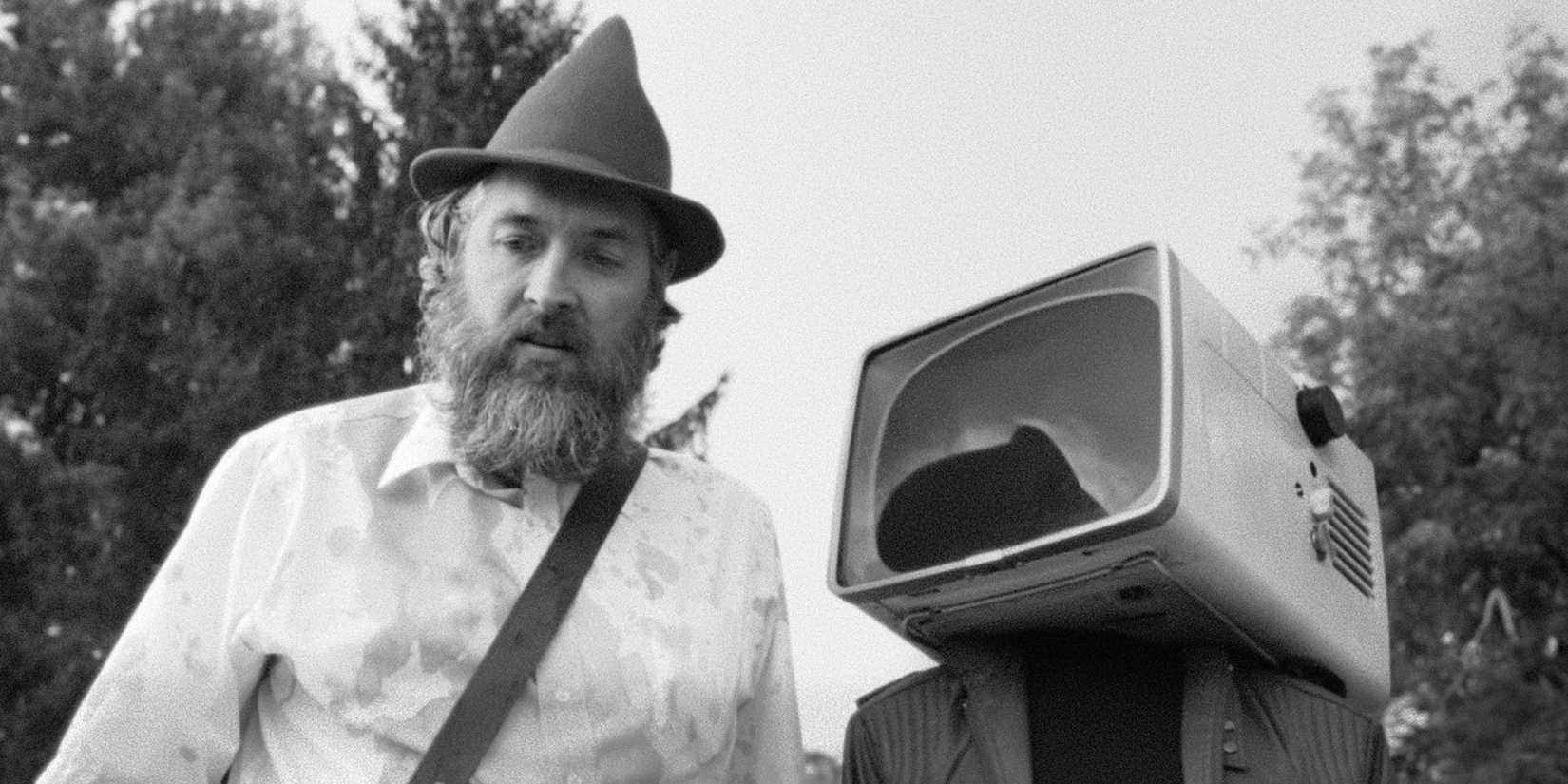 A man next to a television in Obex