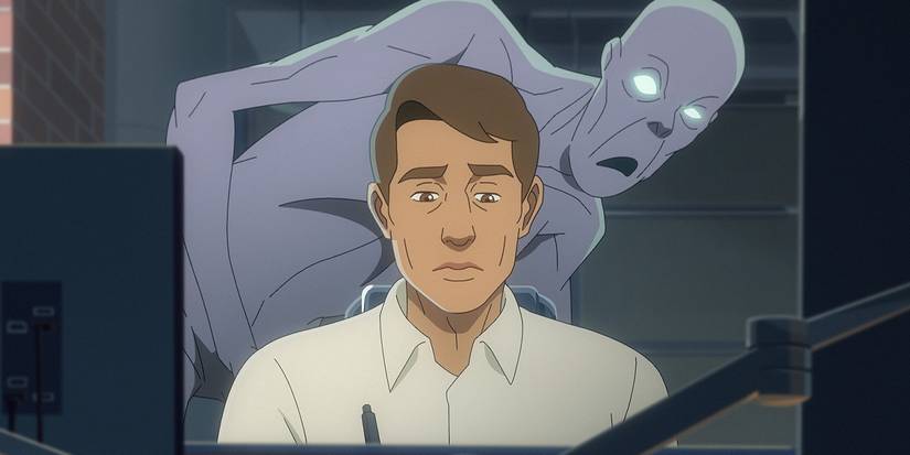 Chanda (Raza Jaffrey) is sitting in the fake world office with a demon behind him on AMC+'s Pantheon