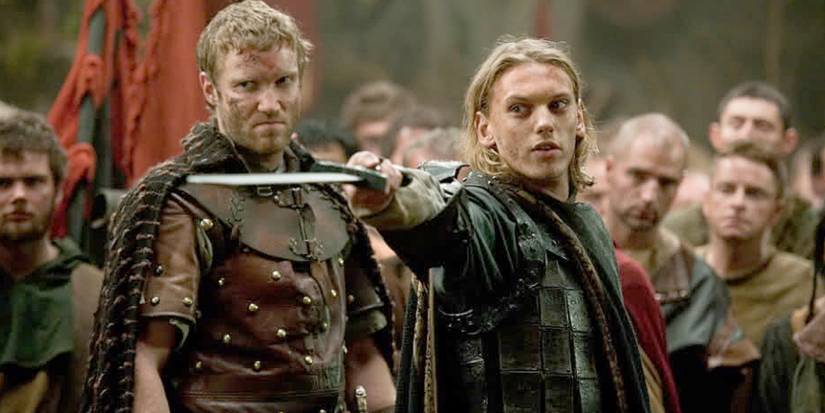 Jamie Campbell Bower as King Arthur holding a sword in Camelot